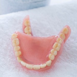Dentures sitting on a towel