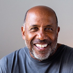 Closeup of senior man in gray shirt smiling