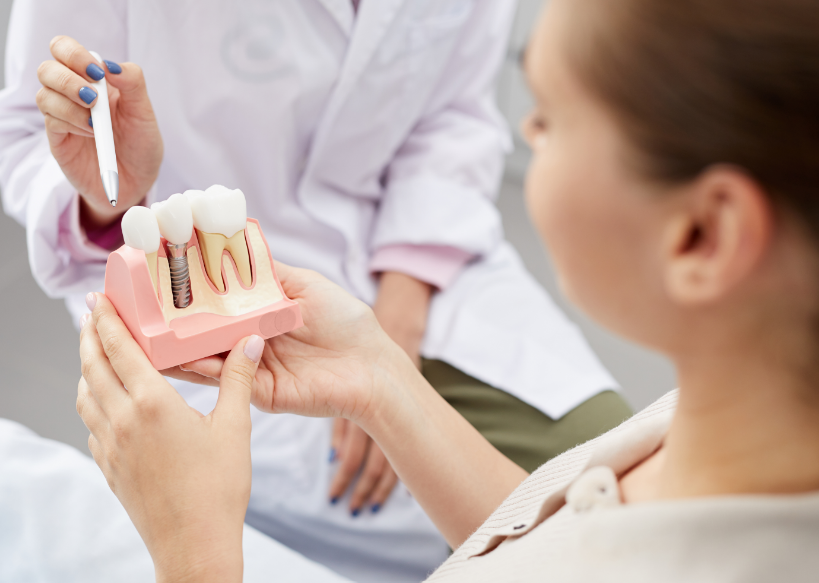 Patient holding dental implant model