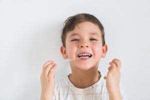 Child flossing.