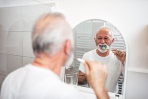 Older adult brushing teeth
